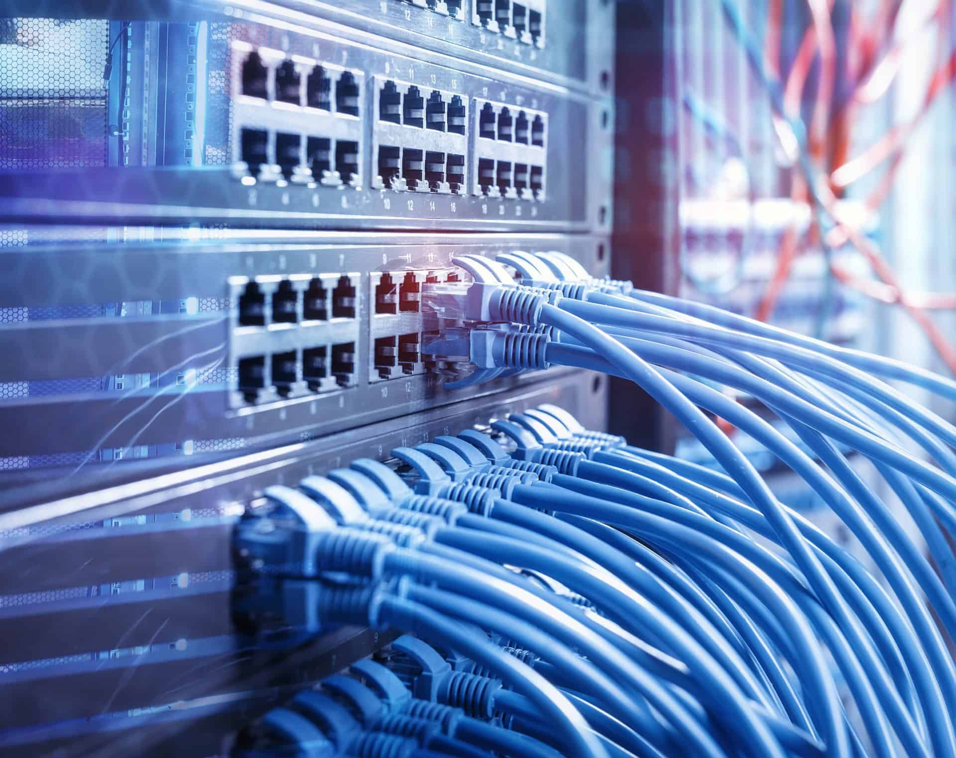 network cables and hub closeup with fiber optical background